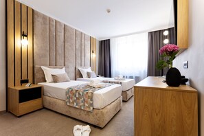 A modern hotel room with a large bed, a desk, and a nightstand. - AMAR Design Hotel by HMG (Sofia)