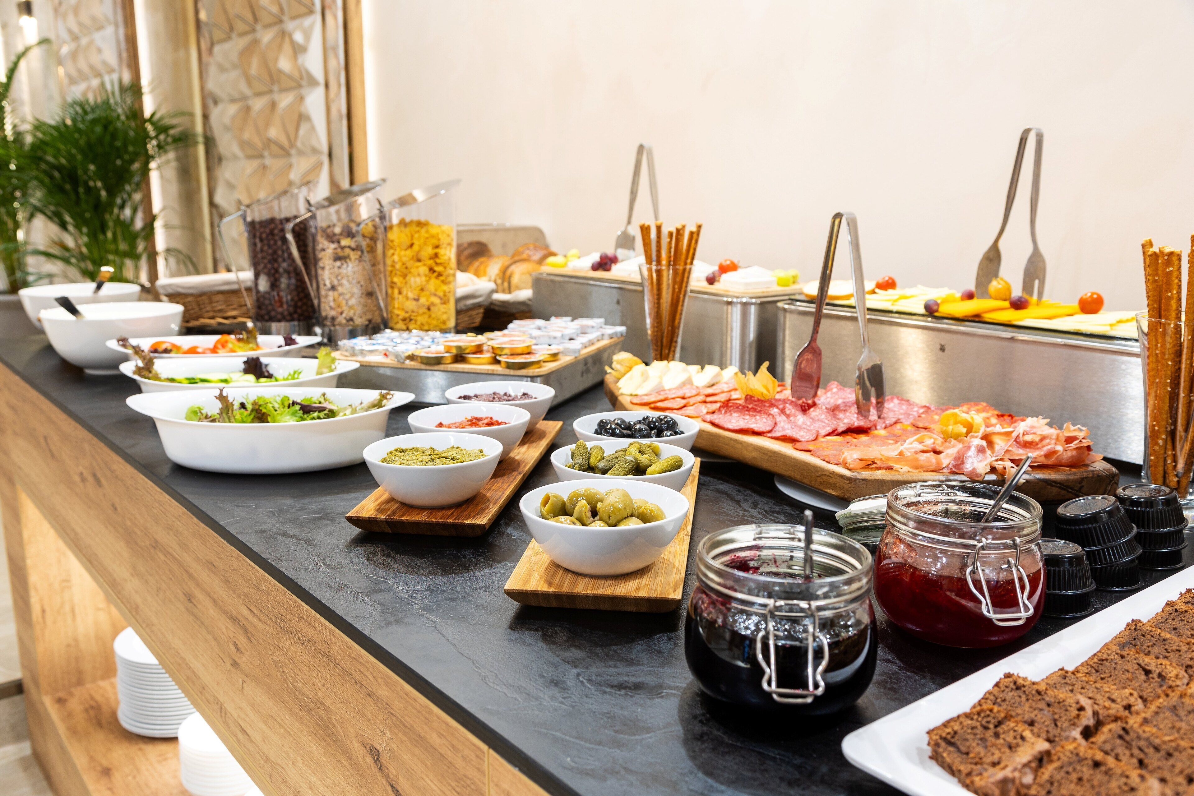 A buffet with various food items and condiments.