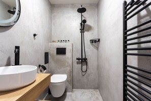 A compact bathroom with a white sink, toilet, and shower. - AMAR Design Hotel by HMG (Sofia)