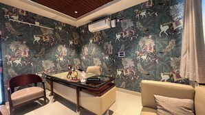 A reception area with a desk, chair, and a couch.