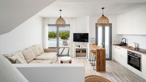 A modern apartment with a living room, kitchen, and balcony. - Villa Isola Plaka Naxos (Naxos)