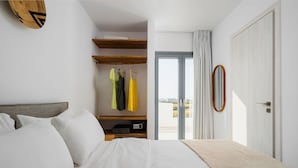 A bedroom with a bed, a wardrobe, and a view through a door. - Villa Kaya Plaka With 3 Bedrooms and 3 Bathrooms (Naxos)