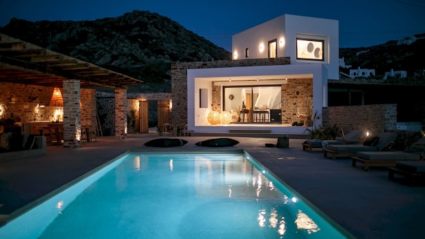 A modern villa with a swimming pool, stone walls, and a dining area. - Villa Anamnisis With 5 Bedrooms and 5 5 Bathrooms (Naxos)