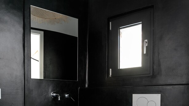 A modern bathroom with a white sink, a mirror, and a toilet. - Villa Andalusia With 4 Bedrooms and 3 5 Bathrooms (Naxos)