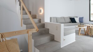 A modern interior with a staircase, a sofa set, and a small table. - Villa Andalusia With 4 Bedrooms and 3 5 Bathrooms (Naxos)