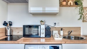 A modern kitchen with a built-in microwave, stove, and sink.