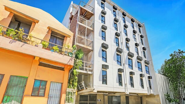 A multi-story building with balconies, large windows, and a flat roof. - MyTown Madrid, Classy Hostel Bunkbeds Makati Metro Manila (Taguig)