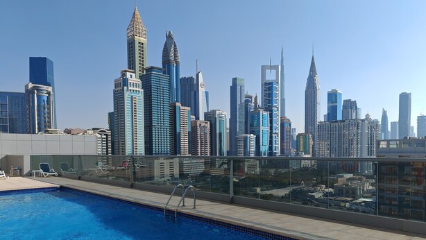 A rooftop pool with a city skyline in the background. - Chic 1-bedroom apartment in enchanting Dubai with WiFi, fitness room (Dubai)
