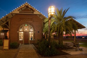 A brick building with a sign reading "Melia Island Welcome Center" and a clock above the door.