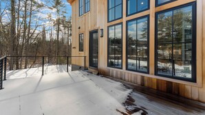 A modern wooden building with large windows and a snow-covered deck. - Luxury Mountain Escape (North Conway)