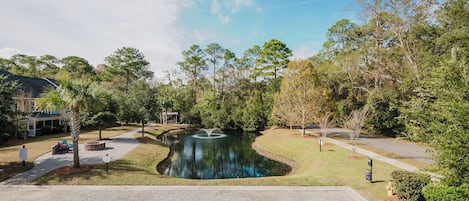 Surrounded by trees and a serene lawn, this tranquil oasis features a central pond and a gazebo for relaxation.