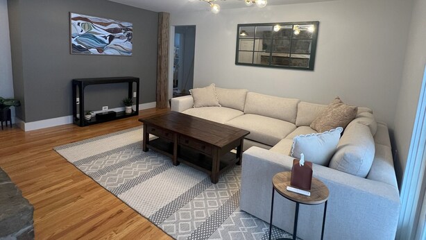 A modern living room with a sofa, coffee table, and a small side table. - Enjoyable a cabin on the Black river with WiFi in Ludlow for a cozy stay (Ludlow)