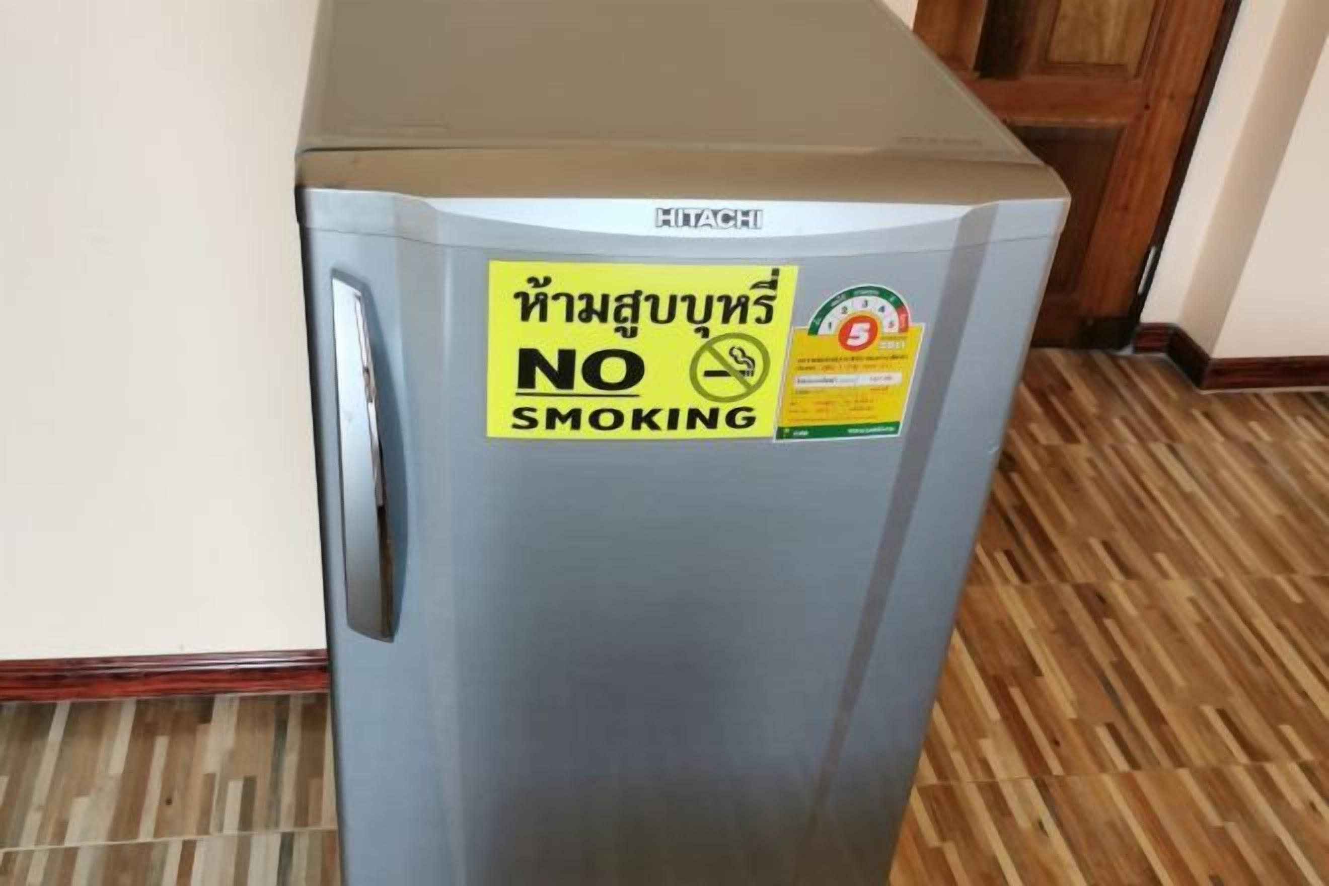 A refrigerator with a 'NO SMOKING' sign on it.
