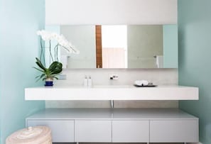 A modern bathroom with a white vanity, a large mirror, and a potted orchid. - Elegant Villa Anar 5 Bed Luxury Beachfront Near Four Seasons (Koh Samui)