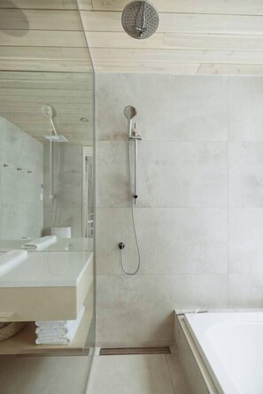 A modern bathroom with a glass shower enclosure, a visible toilet, and a large mirror. - TOPAZ (Lac-Beauport, Quebec)
