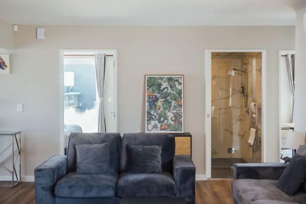 A modern living room with a grey sofa, a small table, and a painting on the wall. - Snowflake Tekapo (Lake Tekapo)