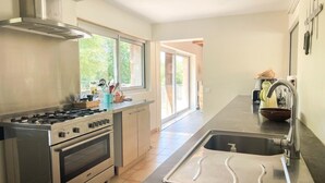 A modern kitchen with a stainless steel stove, oven, and sink.