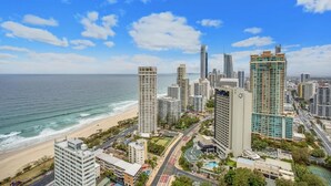 A coastal cityscape with high-rise buildings, a beach, and a clear sky. - Mantra Sun City Surfers Paradise (Gold Coast)