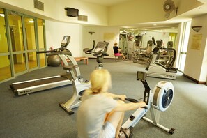 A gym with cardio machines, a treadmill, and a rowing machine. - Mantra Sun City Surfers Paradise (Gold Coast)