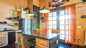 A kitchen with a central island, wooden cabinets, and pendant lighting. - New, Amazing, Cozy, Jacuzzi, Mountain Views, Minutes 2 Downtown, Snow Bowl (Flagstaff)