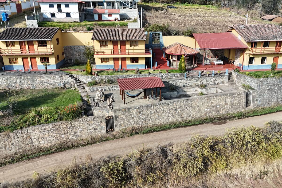 A residential area with houses featuring stone walls and tiled roofs.