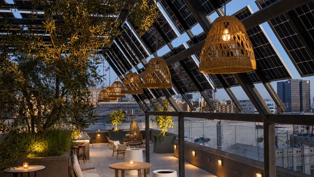 A rooftop terrace with solar panels, outdoor seating, and a view of the cityscape. - Whisky Hotel  (Los Angeles)