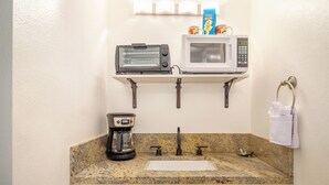 A kitchen with a microwave, toaster, coffee maker, and a sink. - Chic Aloha Studio in Superb Princeville, w/AC & WiFi 
Explore Beautiful Napali! (Princeville)