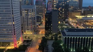 A cityscape with high-rise buildings, a wide road, and a parking area. - Cozy 1-bedroom condo in delightful Minneapolis with AC, WiFi, fitness room (Minneapolis)
