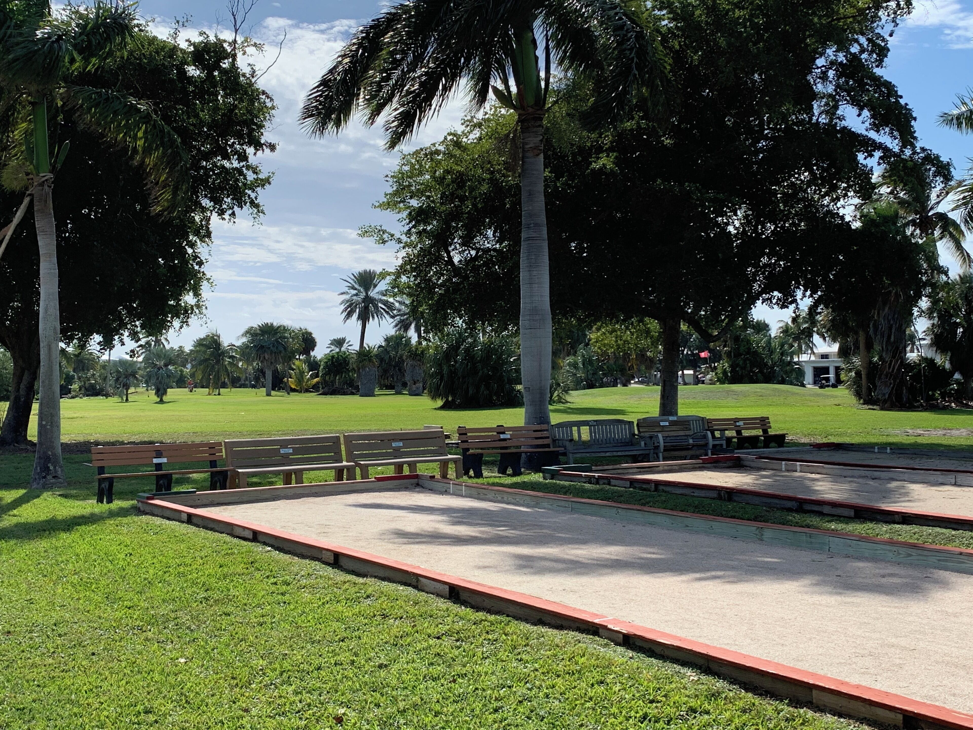 A park with benches and a paved area.