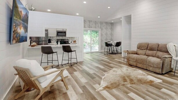 A modern living room with a sofa, chairs, a rug, and a mounted deer head. - Cozy Mountain Hideaway, Next to Hiking Trails & Waterfalls! (Highlands)