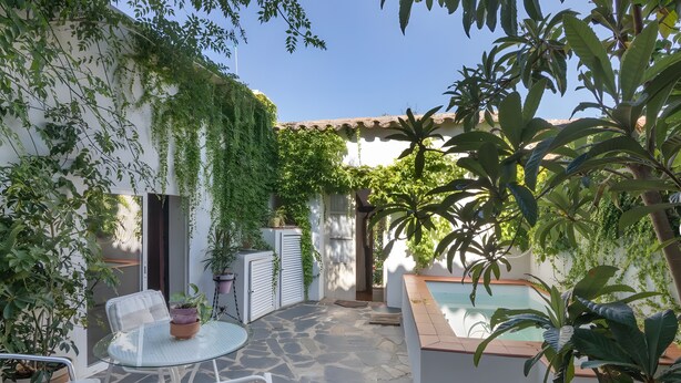 A patio with stone flooring, white furniture, and potted plants. - Country House 'La Rana Verde De Arriba' with Mountain Views, Private Terrace & Wi-Fi (Los Romeros)