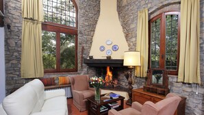 A cozy living room with stone walls, a fireplace, and comfortable seating. - Holiday Home 'Chianti Loft' with Mountain View, Wi-Fi and Air Conditioning (Greve in Chianti)