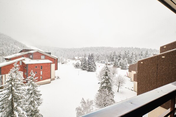 A snowy landscape with buildings and trees.