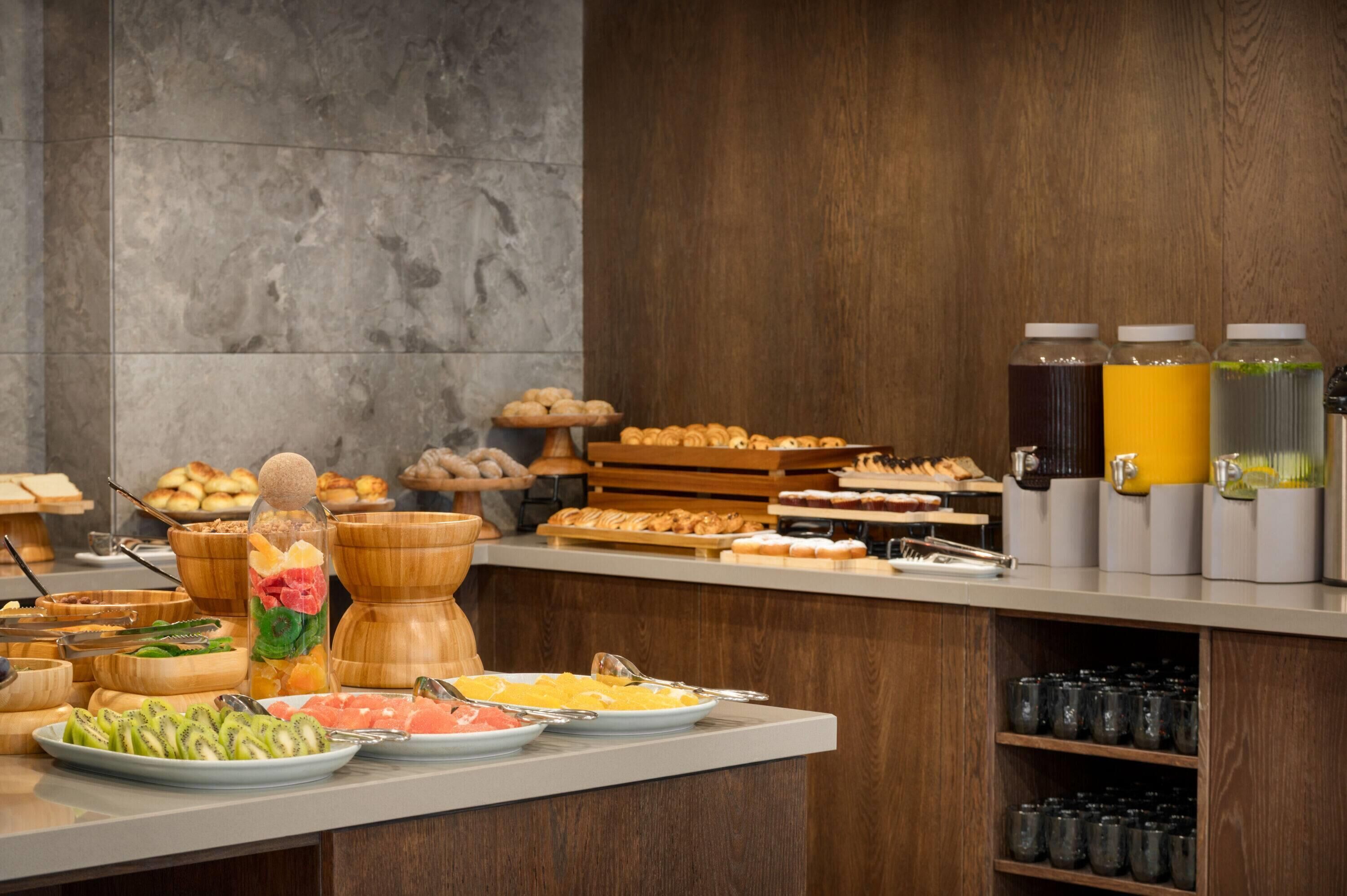 A buffet with various food items and beverages.