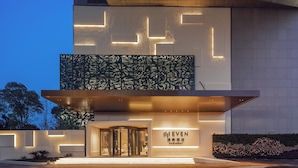 A modern hotel entrance with a revolving door, illuminated geometric patterns, and a sign reading "EVEN". - EVEN Hotel Shanghai Jinqiao by IHG (Shanghai)