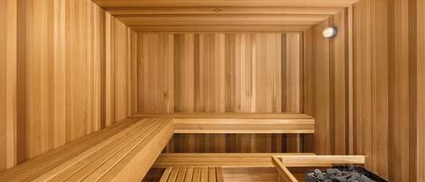 A sauna with wooden benches and a bench with a charcoal container.