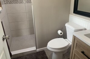 Shower, hair dryer, towels, toilet paper