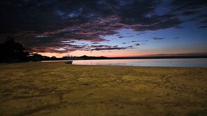 A beach at sunset with a calm sea and a clear sky. - Lovely 2 bedroom home with large Private salt water pool in beautiful Tamarindo. (Tamarindo)