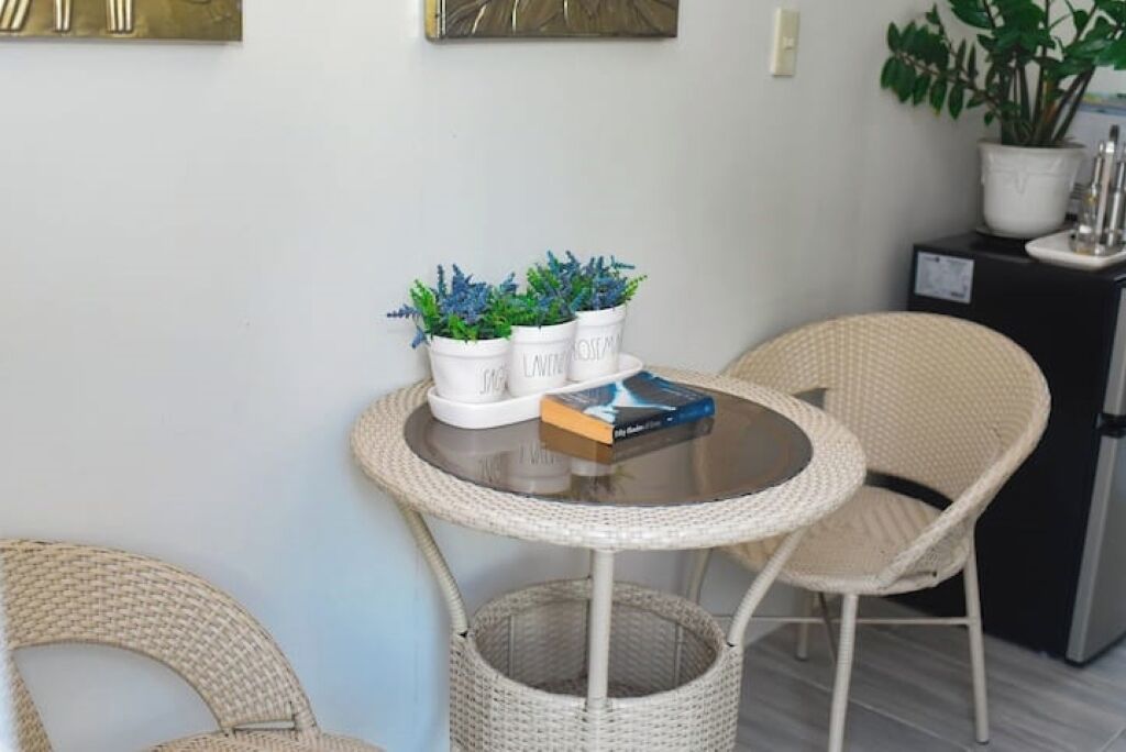 A round table with a book and three potted plants.