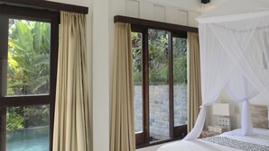 A bedroom with a large bed, a canopy, and a view of an outdoor swimming pool. - Umah Kemuning Near Central Ubud Bali (Bali)