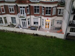 Stunning traditional building with a mix of brick and plaster exteriors, featuring a balcony and outdoor seating area.
