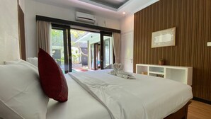 Ein Hotelzimmer mit einem großen Bett, einem Schreibtisch und Blick ins Freie.