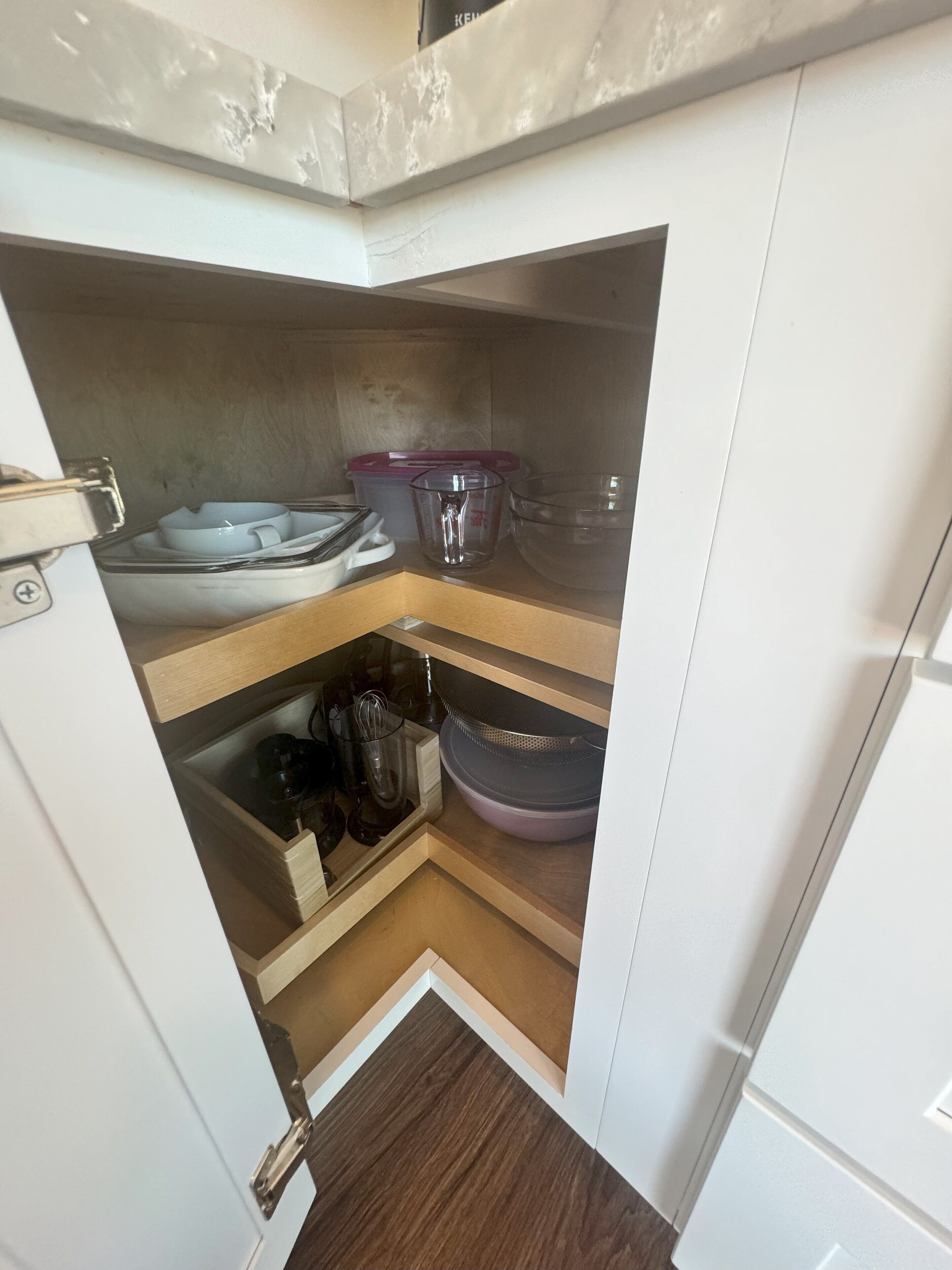 A compact kitchen with a built-in microwave, a small sink, and storage cabinets.