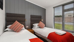 A hotel room with two beds, grey walls, and a window with blinds. - The Duck Pond - Countryside Hot Tub (Narberth)