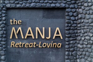 A sign with the text "the MANJA Retreat-Lovina". - The Manja Retreat Lovina Bali (Sukasada)