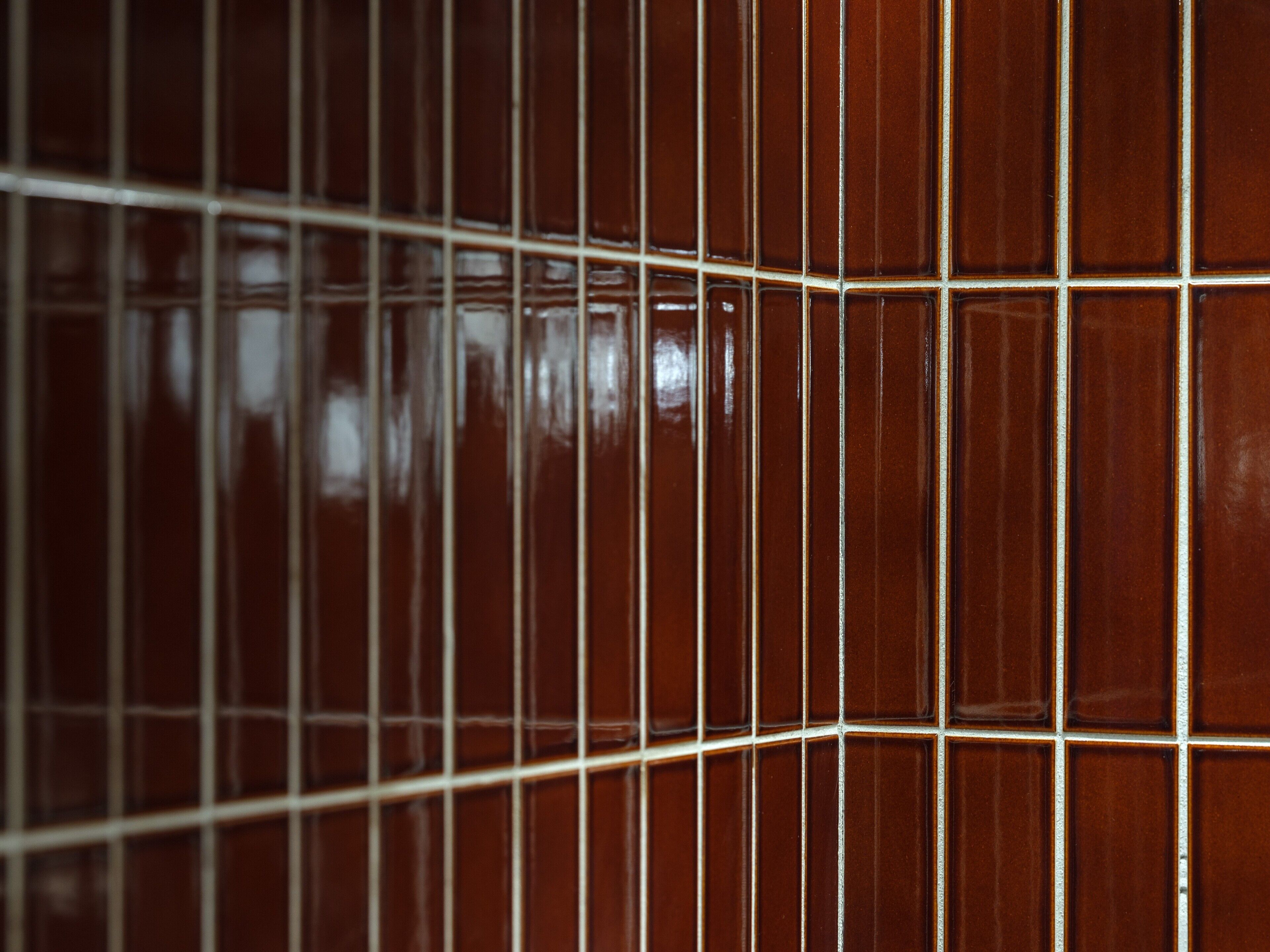 A close-up of a tiled wall with a grid pattern.