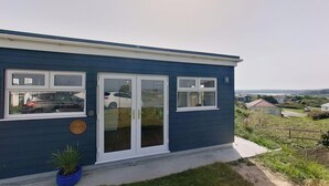 A blue house with a front door, two windows, and a small garden. - D46 Wrangarrie, Riviere Towans (Hayle)