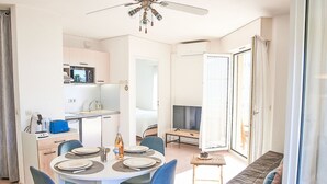 A modern living room with a dining area, a kitchen, and a balcony. - Les Rives Latines by Interhome (Fréjus)