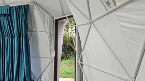 A tent with a partially open door, revealing a grassy outdoor area. - Mountain view dome, pet friendly, trails and near Poas Volcano. (Carrizal)