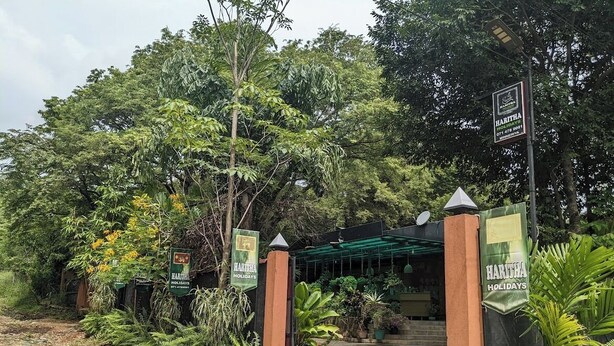 A gated entrance with a sign for Haritha Holidays.